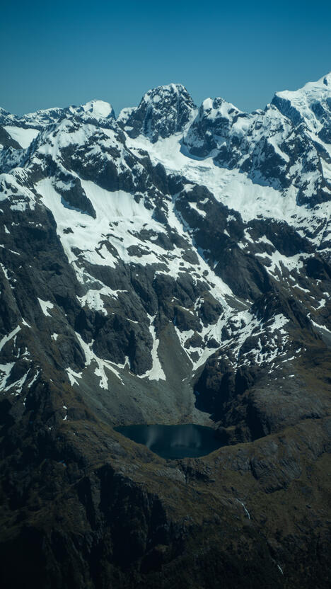 A lake embedded in the mountains (photo taken on flight to Milford Sound)