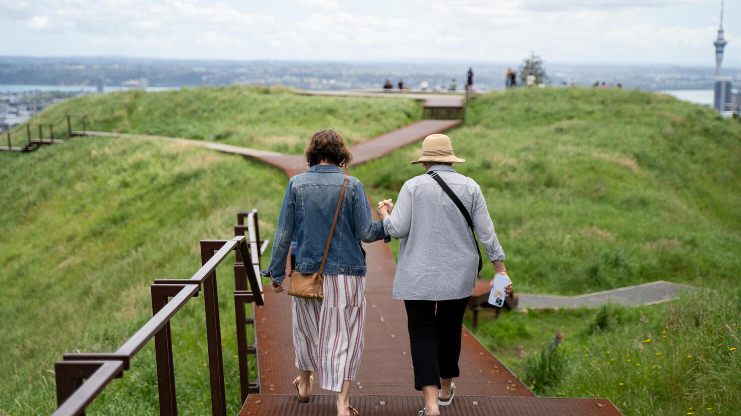 My Mom (left) and Grandma (right) holding hands while walking atop Mount Eden