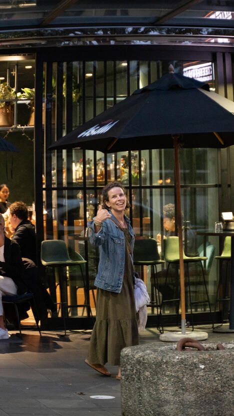 My mom gesturing for me to follow her and stop taking photos.