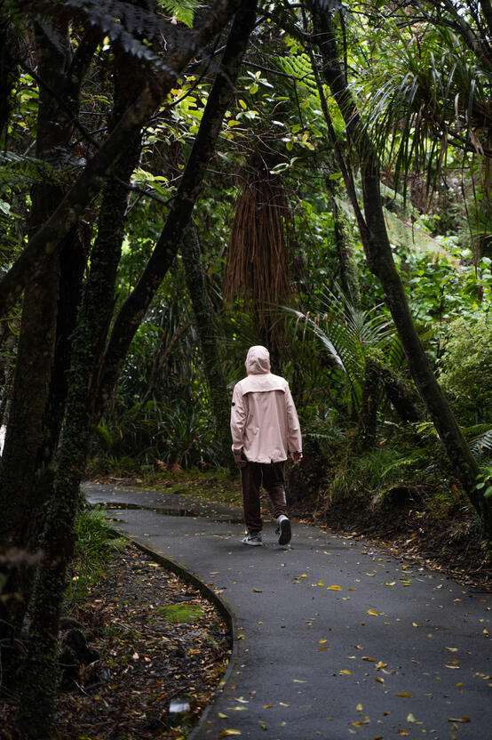Palmer walking through the green paths at Pancake Rocks