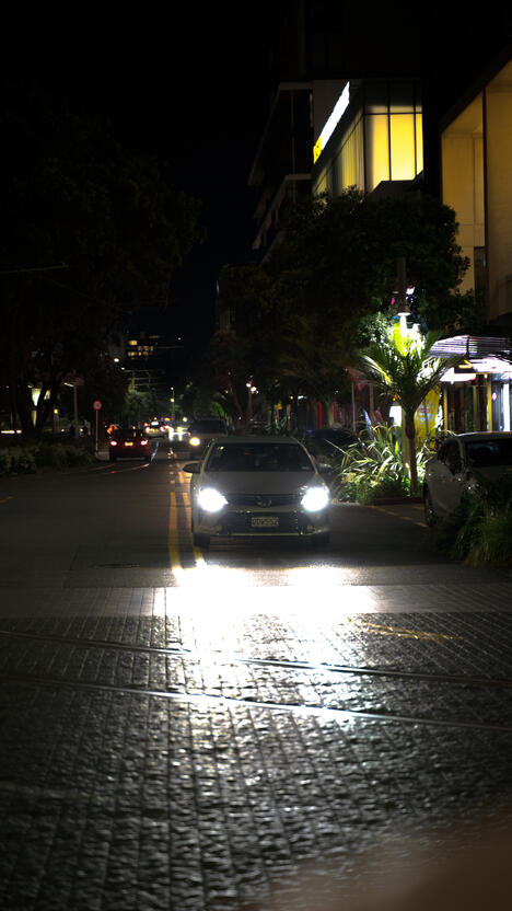 Car driving through Auckland at night