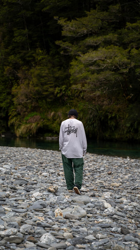 Palmer examining the rocks on a small riverbed