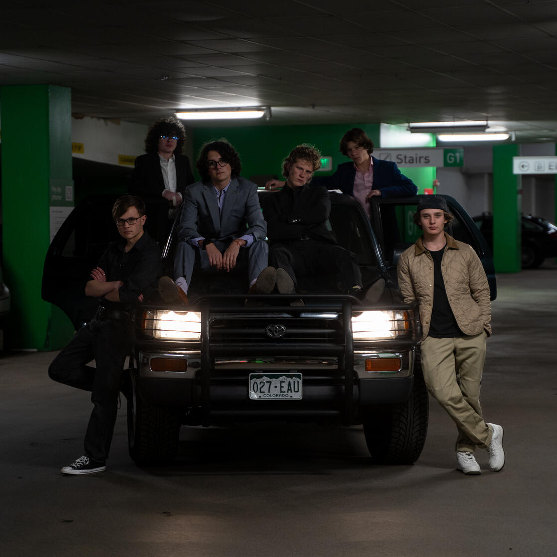The Men looking cool as hell on top of a car