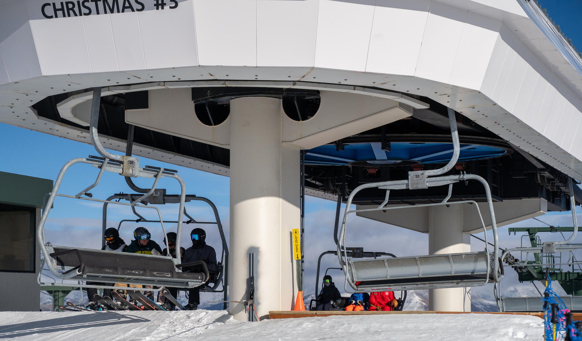 Closeup of people getting off the chairlift